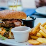 close-up-of-a-juicy-burger-and-crispy-fries-served-with-sauces-perfect-for-a-hearty-meal